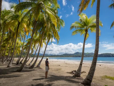 Nainen seisoo Playa Sámaran rannalla ja katsoo merelle